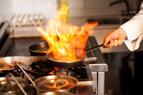 Chef cooking in kitchen stove