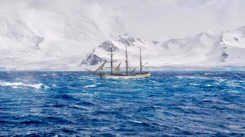 Extreme sailing conditions in Antarctica, as a three masted schooner sails south in a gale, passing the snow-capped mountains and glaciers of the South Shetland Islands.