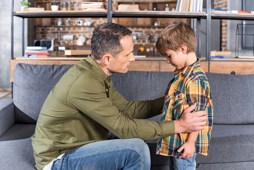 father talking to depressed son