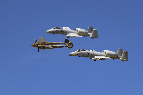 Airplane Heritage Flight with A-10 Thunderbolts and vintage P-38 Lightning aircraft performing a fly-over at the 2017 Los Angeles Air Show in Lancaster, California