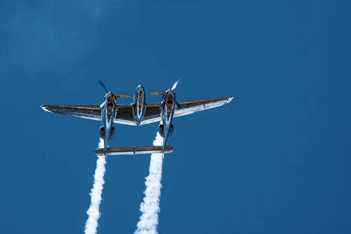 Double tail plane P-38 "Lightning" in airshow with blue sky