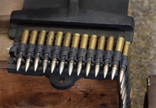 Linked belt of British 0.303 cartridges for Browning aircraft machine guns.