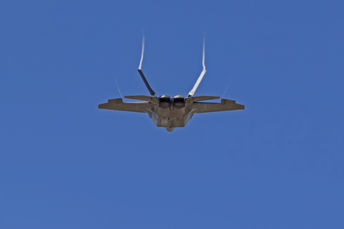 Airplane F-22 Raptor military stealth jet performing at the 2018 Los Angeles Airshow. Los Angeles, California, USA / March 23,2018. The F-22 Raptor performs along with other military and civilian flying acts.