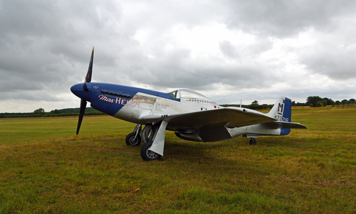 LITTLE GRANSDEN, CAMBRIDGESHIRE, ENGLAND - AUGUST 29, 2021:  Vintage North American P-51D Mustang Aircraft "Miss Helen" on airstrip.