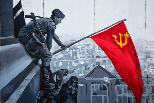 MOSCOW, RUSSIA - APRIL 5, 2016: A Soviet soldier raises the flag in honor of the victory in World War II. Graffiti on the wall of the building. Holiday - Victory Day On May 9
