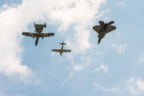 Chicago, IL - August 20th, 2017: An F-22 Raptor, P-51 Mustang and A-10 Thunderbolt II plane fly together over the city for the heritage pass during the annual Air and Water show.