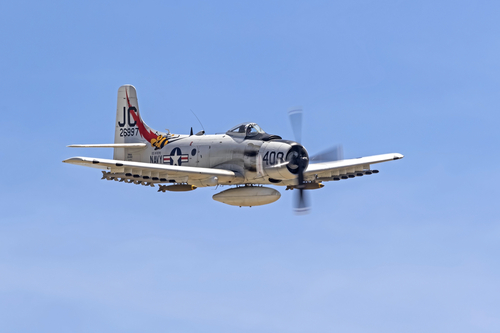 Airplane Korean War A-1 Skyraider flying at Planes of Fame Airshow. Chino, California, USA - May 5, 2018. Planes of Fame Airshow in Chino, California features 2 days of vintage aircraft and modern jets flying for the general public.
