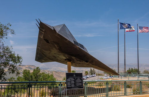 Simi Valley, California, USA - April 27, 2022: Ronald Reagan Presidential Library. Authentic F-117A nighthawk first operational stealth aircraft in front of wide hilly landscape.