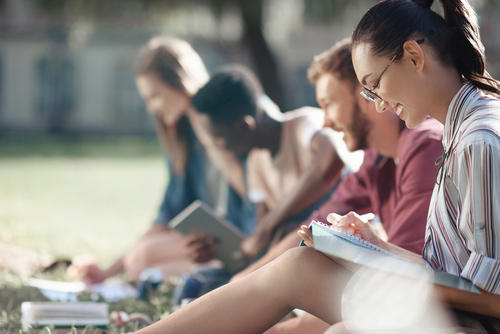 multicultural students studying in park 