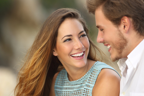 Funny couple laughing with a white perfect smile