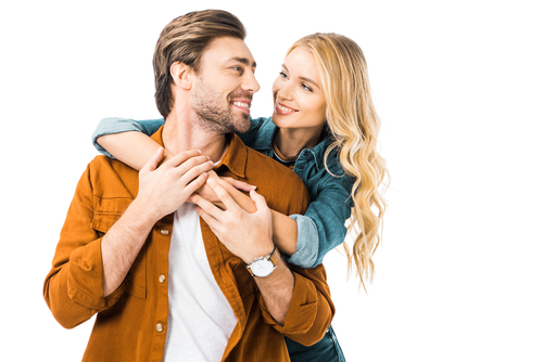 happy young couple embracing and looking at each other isolated on white 