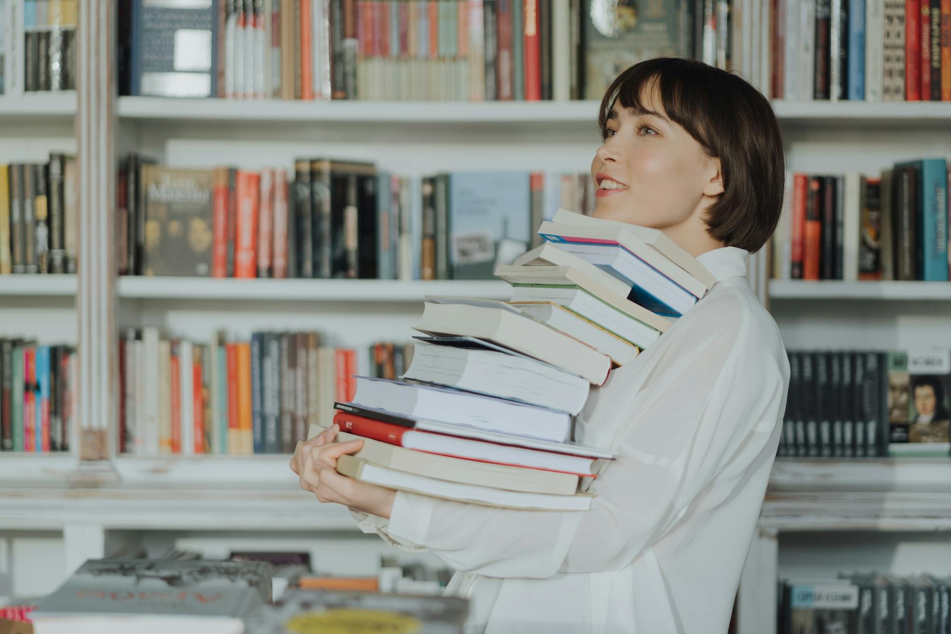 woman in white long sleeve shirt reading books