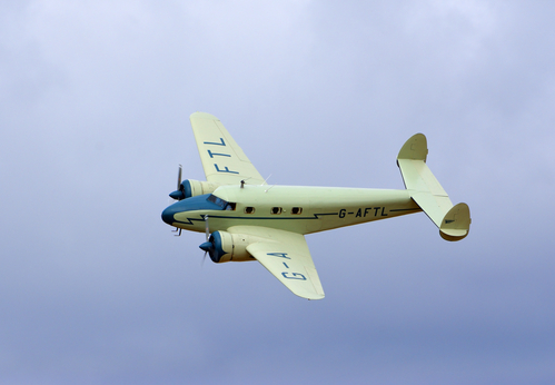 LITTLE GRANSDEN, CAMBRIDGESHIRE, ENGLAND - AUGUST 27, 2022: Vintage Lockheed 12A Electra Junior in flight
