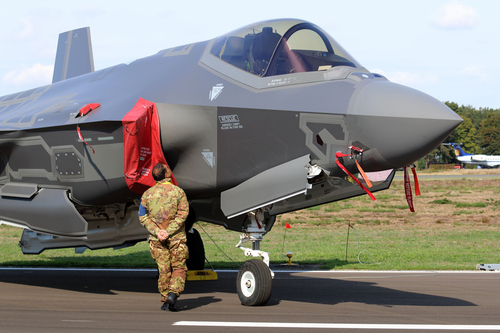 Kleine Brogel, Belgium - SEP 08, 2018: Italian air force Lockheed Martin F-35 Lightning II standing on the road while an Italian soldier is admiring the new aircraft.