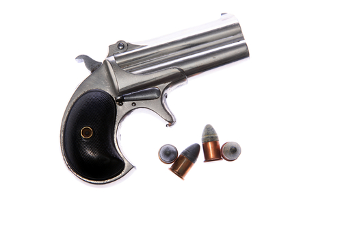 Pistol. Hand Gun. 1887 Remington Arms Company .41 caliber rim fire over and under double derringer pocket pistol. Isolated on white. Room for text. Clipping Path. Derringer Pistol. Gamblers Pistol. Woman's Gun. Self Protection. Antique Derringer 1887