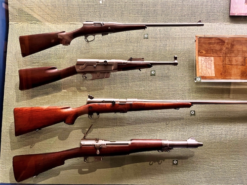 antique rifles on display in a museum.