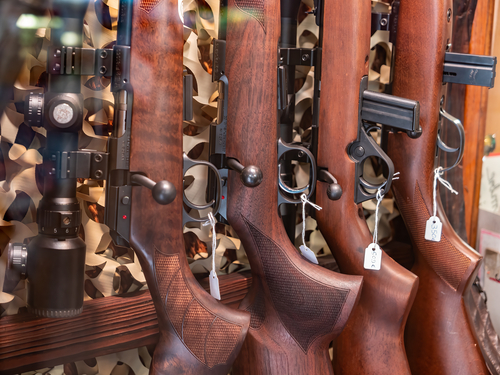 Annecy, France - January 7, 2022: Rifles in the display case of a firearms store in Annecy
