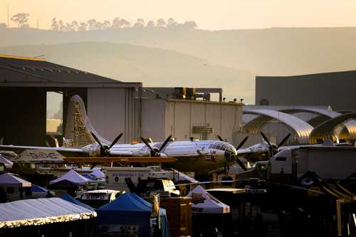 The sun rises on a B-29 named Doc and workers preparing for the opening of America's Airshow in Miramar, California.