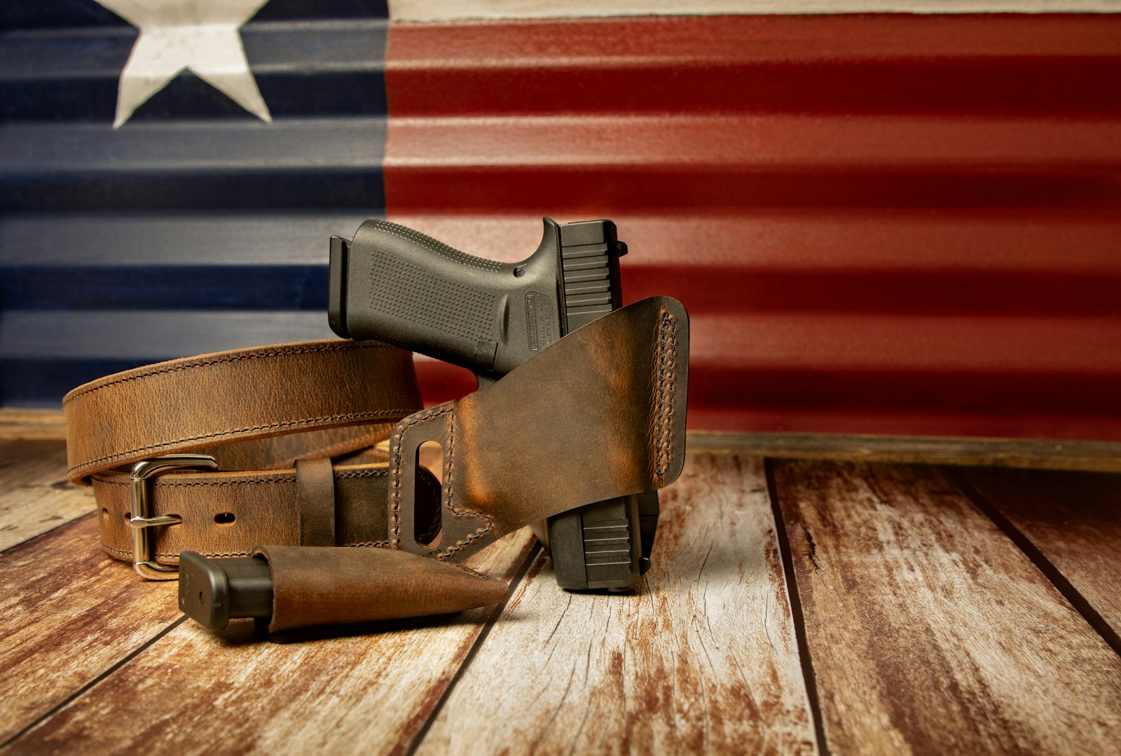 a gun and a holster on a wooden table