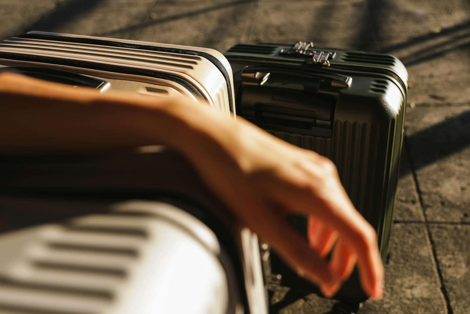 a hand is reaching for a piece of luggage