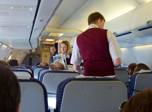 Moscow, Russia - May 14, 2013: The flight attendants give the passengers fresh press