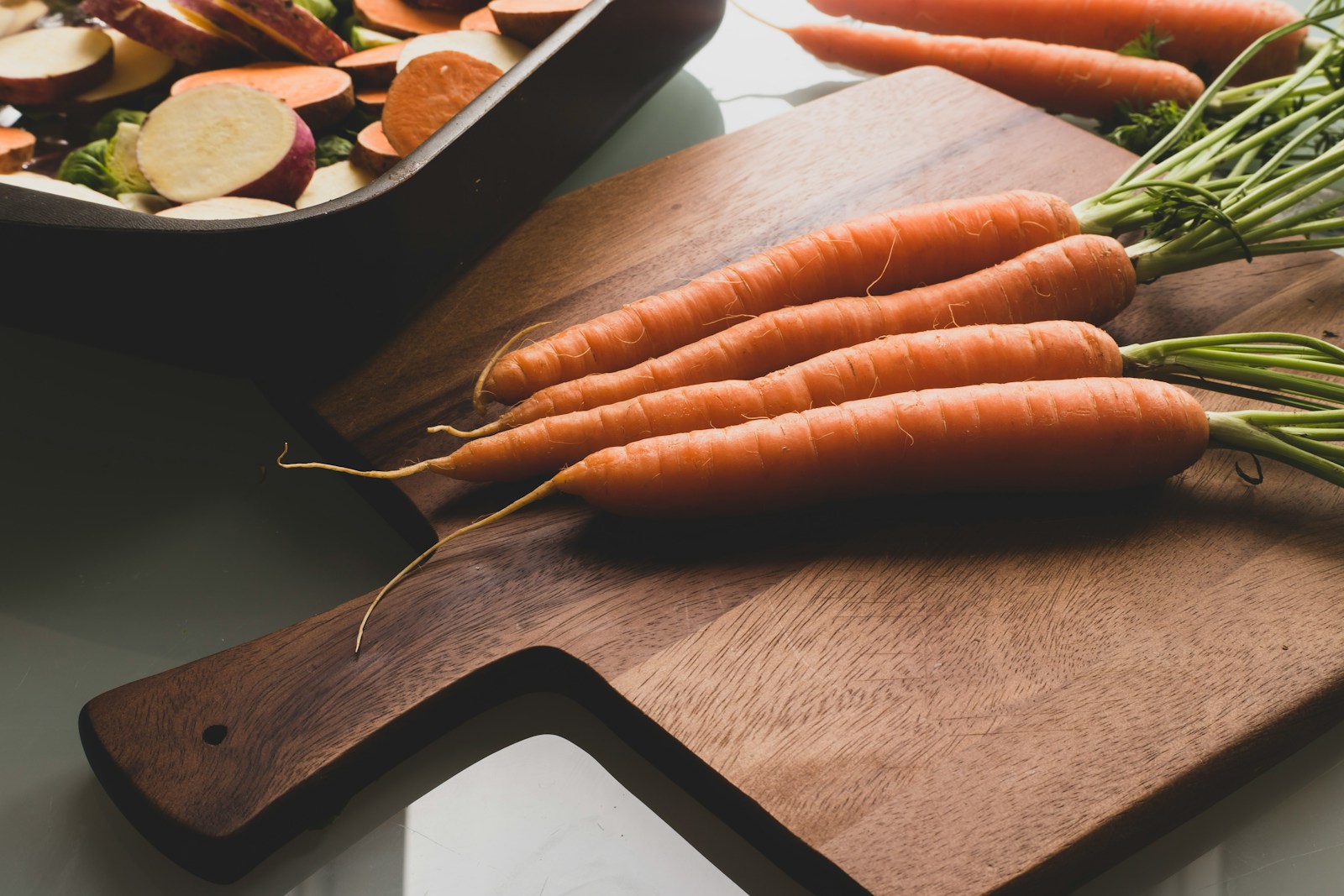 orange carrots on brown wooden table